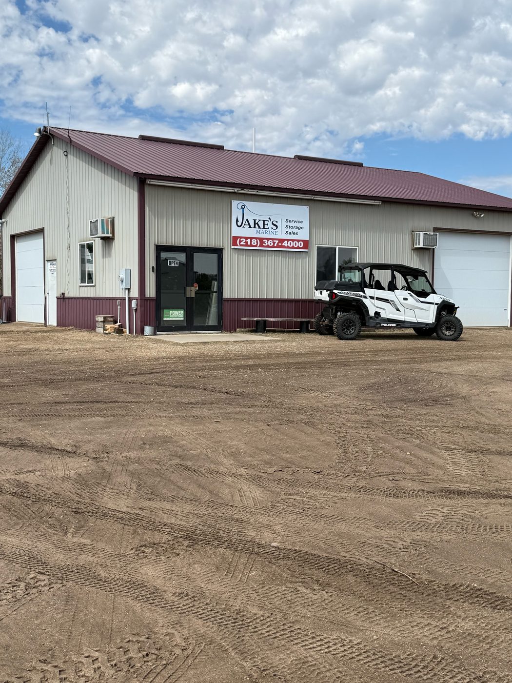 Jake's Marine storefront on Main Street with a UTV out front